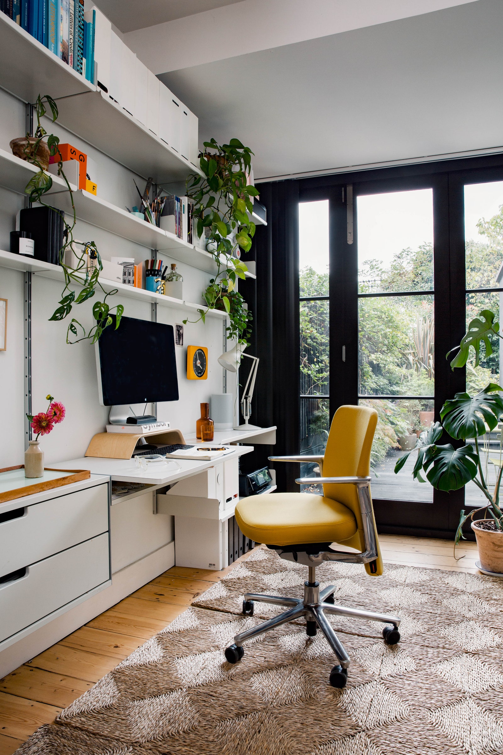 A studio handsomely fitted out with Vitsoe shelving and an integrated desk at Tom and Connie Barton's London house