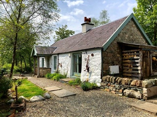 Image may contain Housing Building Cottage House Cabin Outdoors Nature Gravel Road and Dirt Road