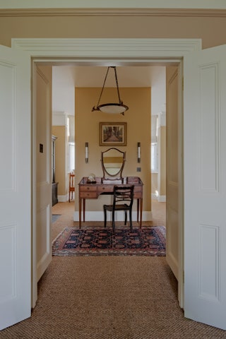 The dressing room of this Victorian house is painted in ‘Bath Stone by Little Greene. The red tones within the shade are...