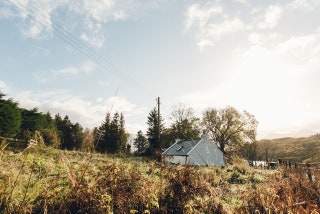 Image may contain Nature Outdoors Tent Building Tree Plant Countryside Fir Abies Rural Housing Hut and Shelter